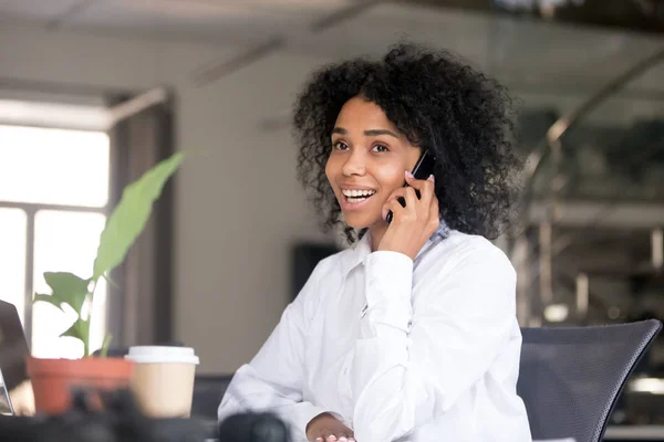 Sorridente donna nera che parla al telefono in ufficio — Foto Stock