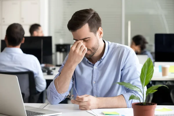 Male employee massage eyes having eye tension at workplace — Stock Photo, Image