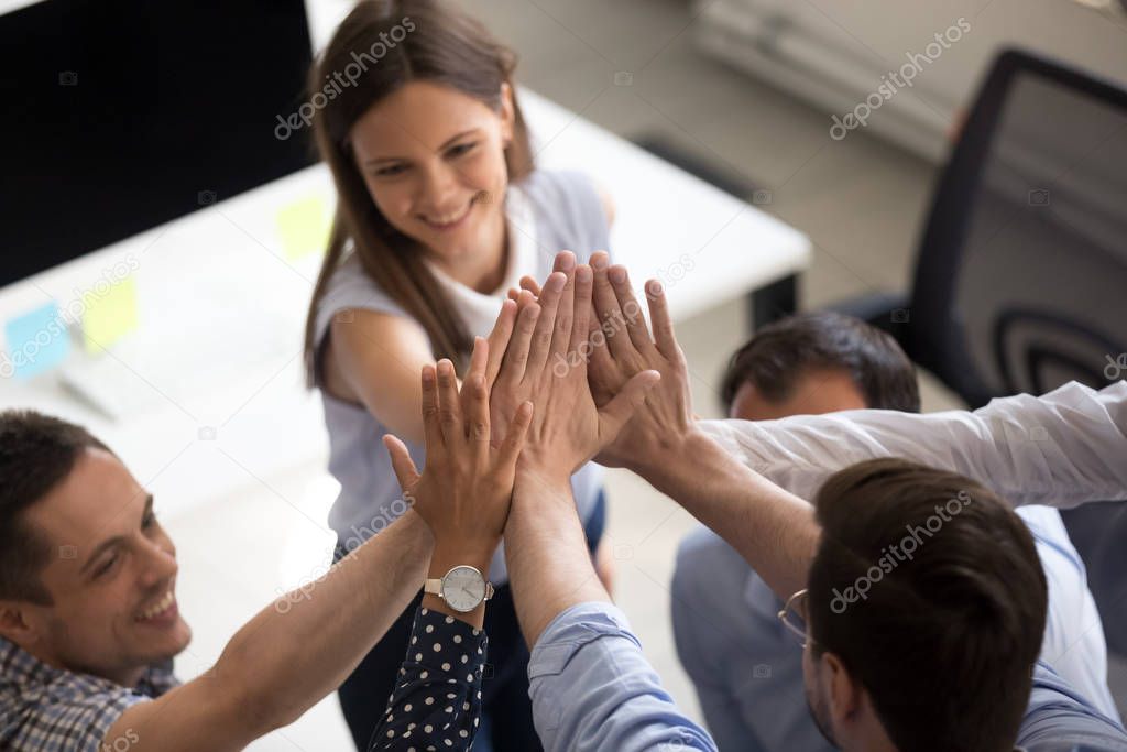 Close up of coworkers give high five motivated for success