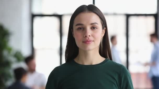 Attractive smiling young businesswoman professional looking at camera in office — Stock Video