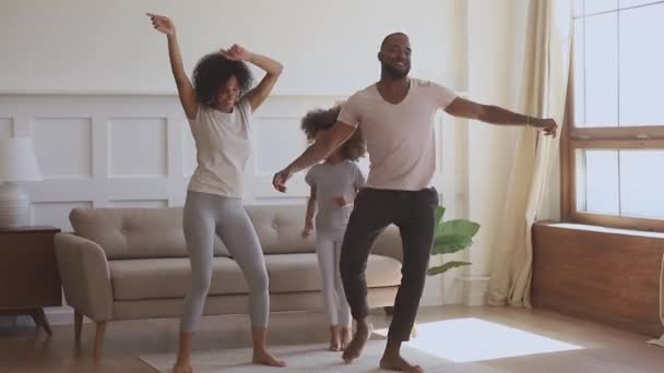 Overjoyed smiling african ethnicity family couple dancing with cute daughter. — 비디오