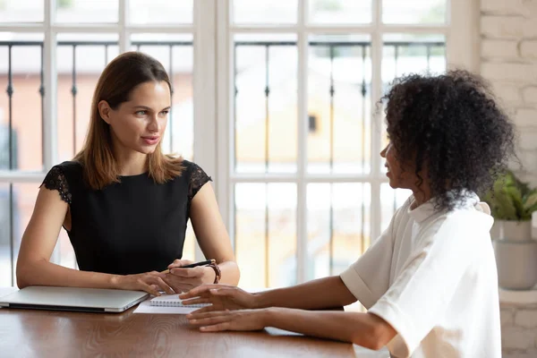 Confident businesswoman hr manager holding interview with African American woman — ストック写真