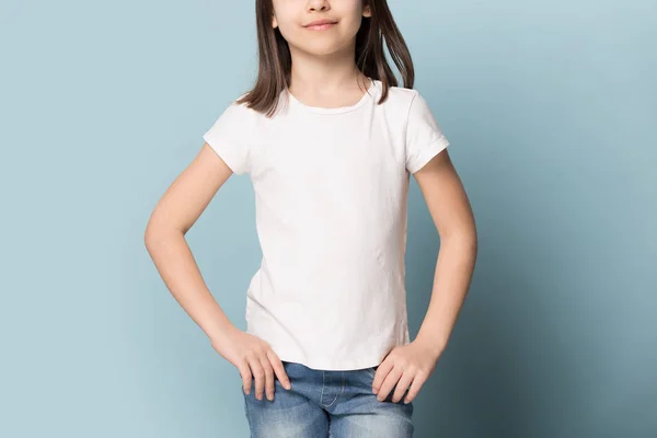 Preschool girl demonstrating white blank mock up copy space t-shirt. — ストック写真