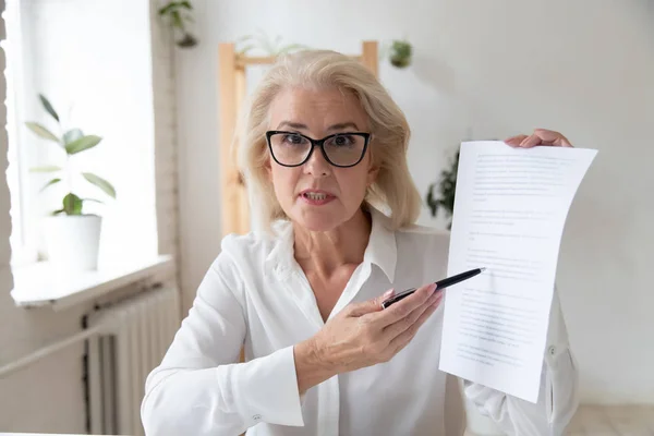 Aged businesswoman giving online presentation discuss contract details distantly — ストック写真