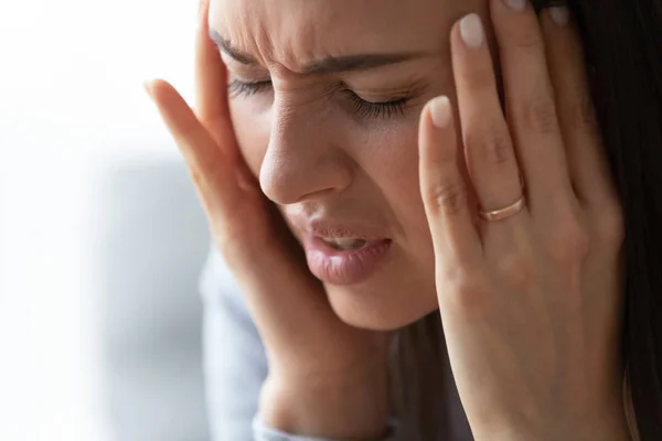 Close up unhappy pressured woman suffering from strong headache — Stock Photo, Image