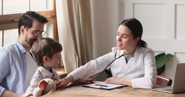Smiling female pediatrician holding stethoscope exam child boy patient — Stock Video