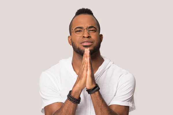 Hopeful black male join hands in prayer believe in luck — Stock Photo, Image