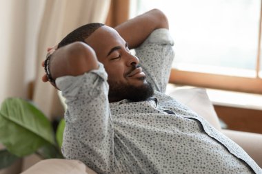 Afrikalı adam gözlerini kapattı. Kanepeye uzandı. Tatmin olduğunu düşünüyor.