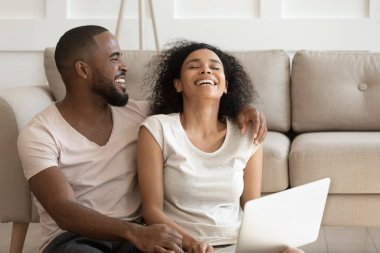 Neşeli Afrikalı çift evlerindeki internet sitelerini kullanarak eğleniyor.