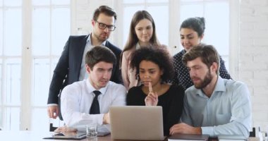 Creative diverse ethnicity millennial business team brainstorming looking at computer