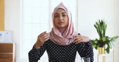 Confident indian muslim business woman speaking looking at camera