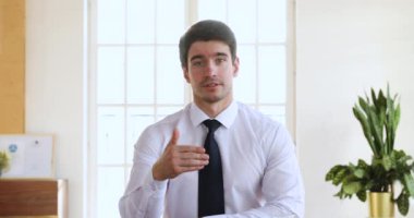 Confident handsome business coach looking at camera conference video calling