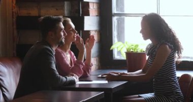 Satisfied smiling clients making agreement with mixed race professional.