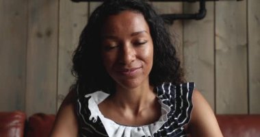 Mixed race financial advisor holding video call with client.