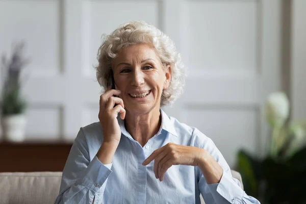 Happy mature older grandmother chatting with grownup children. — 스톡 사진