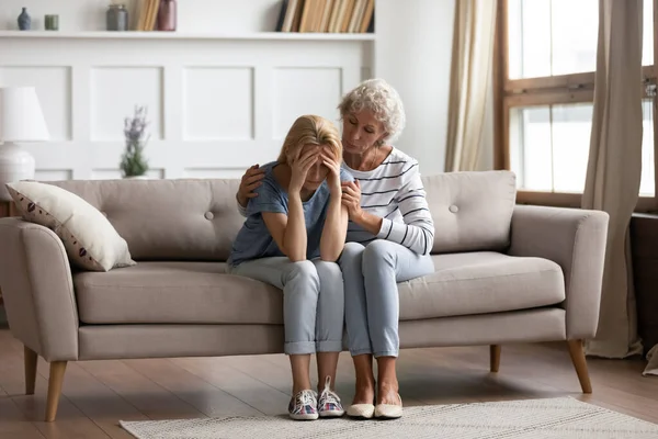 Empathic middle aged mother showing support to grown up daughter. — Stock Photo, Image
