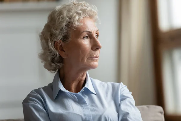 Head shot close up thoughtful middle aged grandmother looking away. — Stock Photo, Image