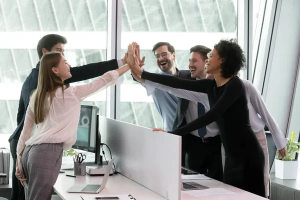 Diversos empleados alegres dando cinco altos, celebrando el éxito final del proyecto . — Foto de Stock