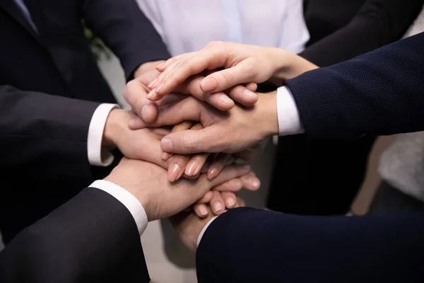 Fermer les gens d'affaires divers empilant les mains ensemble montrant l'unité . — Photo