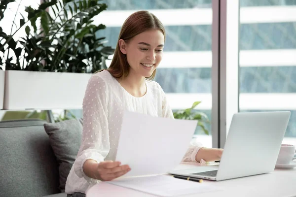 Happy young company employee holding documents, satisfied with report results. — Stock Photo, Image