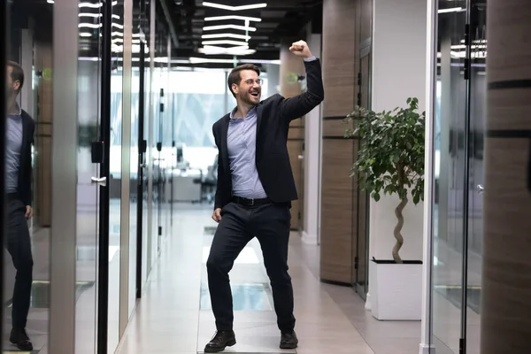 Overjoyed young businessman in suit celebrating job promotion. — Stock Photo, Image