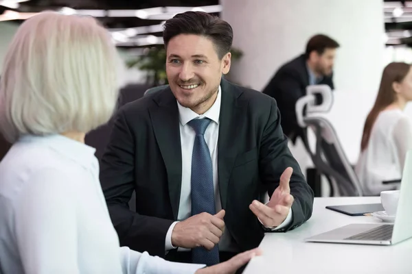 Happy different ages colleagues involved in interesting conversation. — Stock Photo, Image