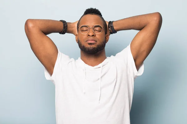 Calm black man relax with eyes closed hands over head — Stock Photo, Image