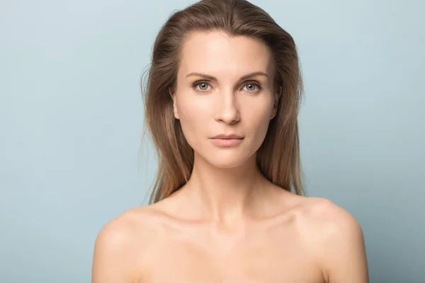 Portrait of beautiful young blue-eyed woman look at camera posing — Stock Photo, Image