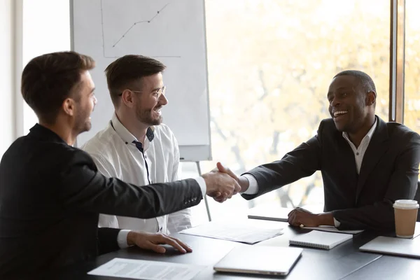Happy African businessman shake hands with European business partner — Stock Photo, Image