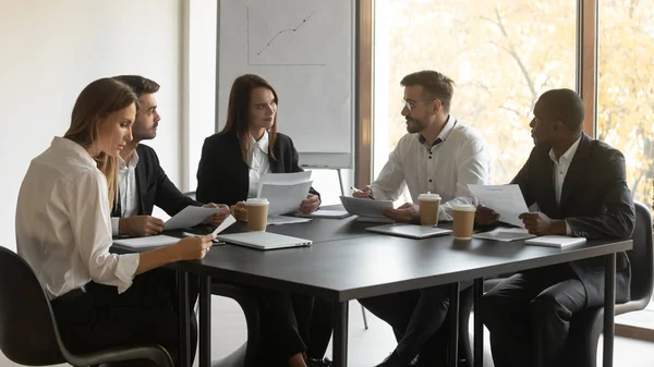 Employees and coach take part in seminar seated at boardroom — Stock Photo, Image