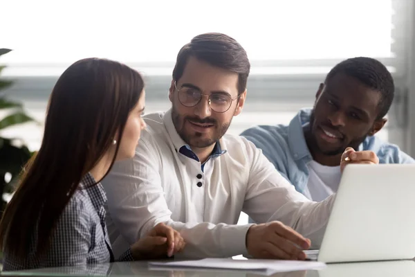 Compañeros de trabajo multirraciales sentados en el escritorio discutir nuevo programa corporativo aplicación — Foto de Stock