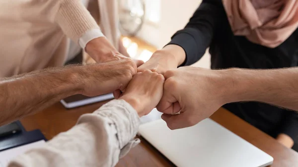 Close up of diverse employees join hands show unity — Stock Photo, Image