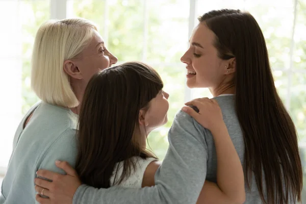 Happy three generations of women hug showing unity — Stock Photo, Image