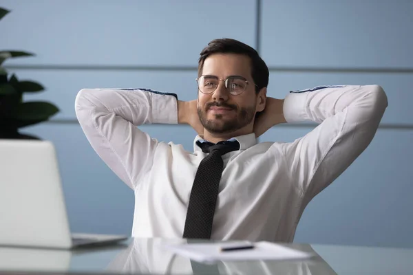 Businessman put hands behind head resting enjoy break at workplace — Stock Photo, Image