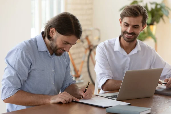 Smiling male employee sign contract close deal at meeting — Stock Photo, Image