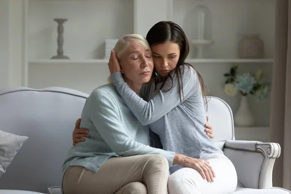 Loving adult daughter cuddle comfort upset mature mom — Stock Photo, Image