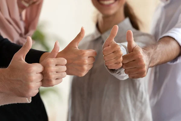 Close up of multicultural colleagues show thumbs up — Stock Photo, Image