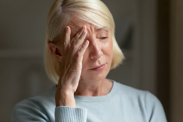 Upset mature woman feel lonely crying from despair