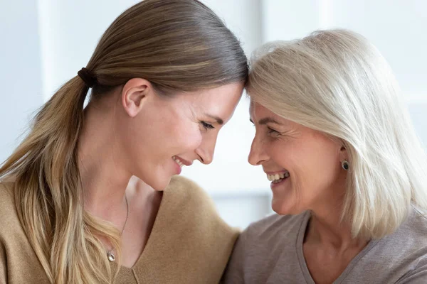 Close up of loving senior mom and adult daughter hugging — Stock Photo, Image