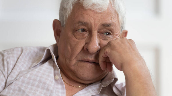 Sad senior man look in distance feeling lonely