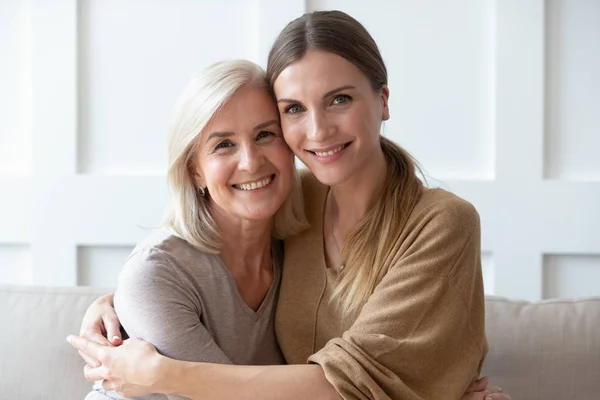 Headshot portrait of mature mom and adult daughter posing — Stock Photo, Image