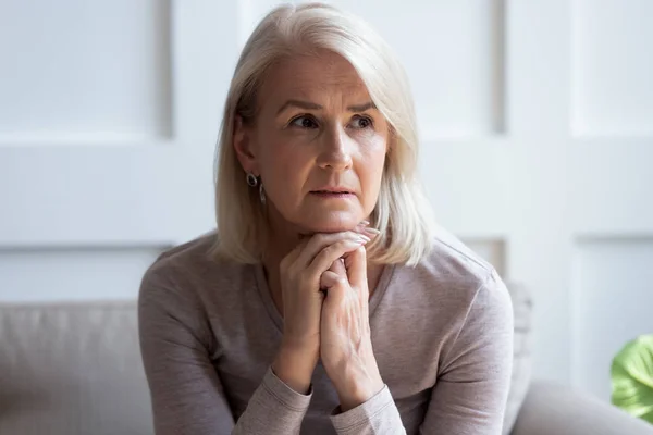 Sad senior woman look in distance thinking or mourning — Stock Photo, Image