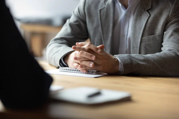 Two businessmen with clasped hands sitting opposite close up — Stock Photo, Image