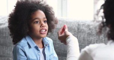 African child girl learning speaking practice sound articulation with therapist