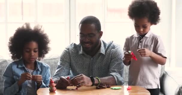 Cute african children and dad sculpting playdough at home — ストック動画