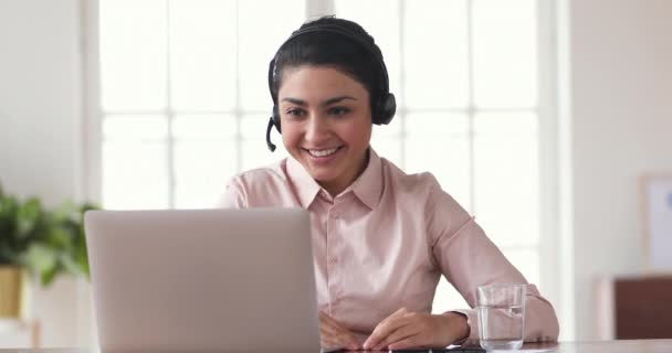 Happy indian businesswoman wear headset conference calling celebrating victory — 图库视频影像