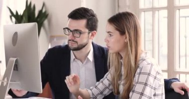 Professional colleagues talking working with pc sit at workplace