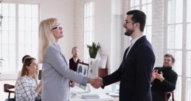 Happy boss handshake promote mature employee appreciate for good work