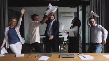 Happy mixed race colleagues enjoying friday party time in office.