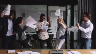 Overjoyed mixed race company stuff celebrating success.